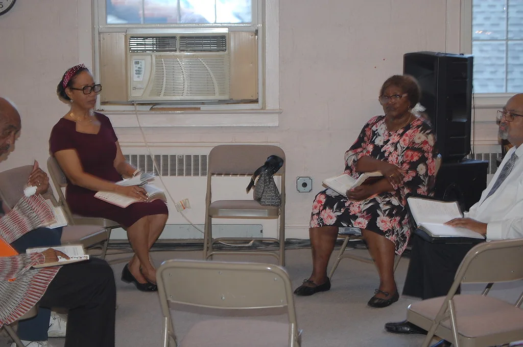 Members seated in a circle with Bibles and notes during a teaching session at Prayer Tower Church